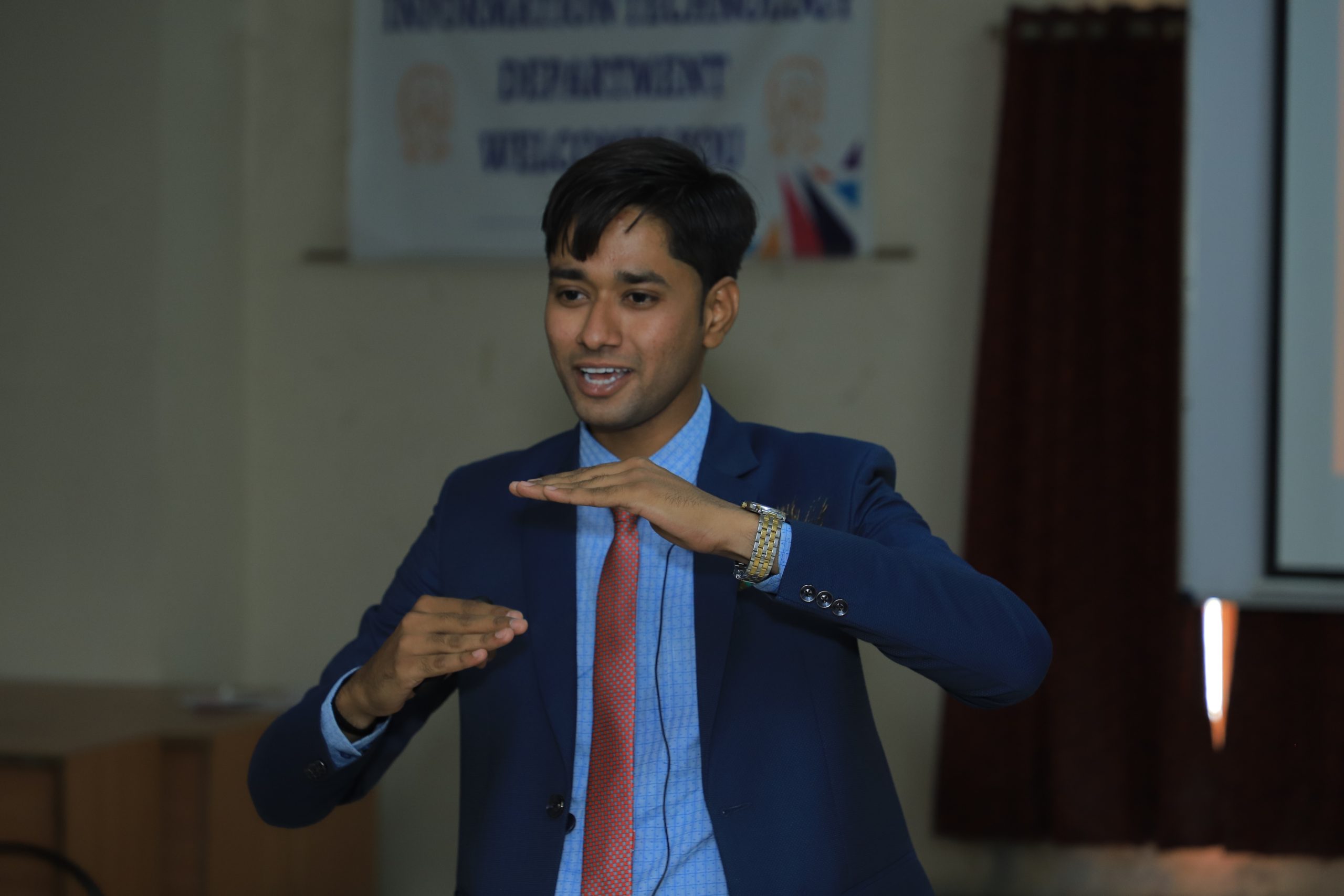 Nirmal Rabari speaking on stage